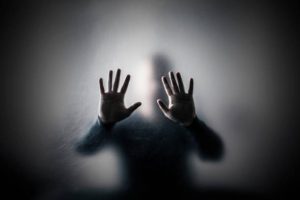 Man behind a scratched glass