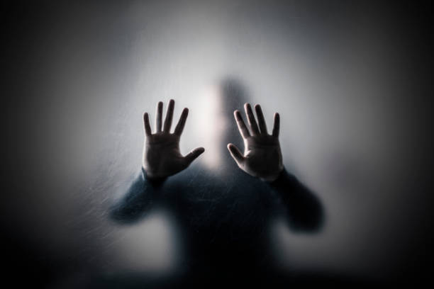 Man behind a scratched glass